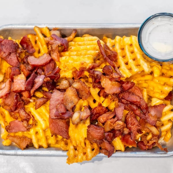 Cajun Crab & Shrimp Bar & Grill's waffle fries loaded with melted cheese and crispy bacon bits.