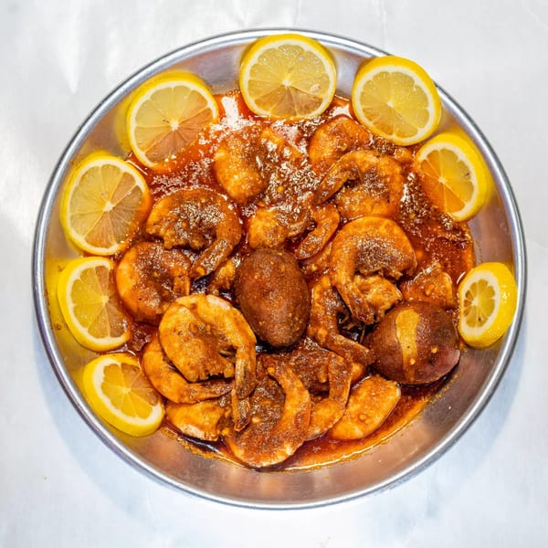Cajun Crab & Shrimp Bar & Grill's shrimp and potatoes in a spicy sauce with lemon slices.